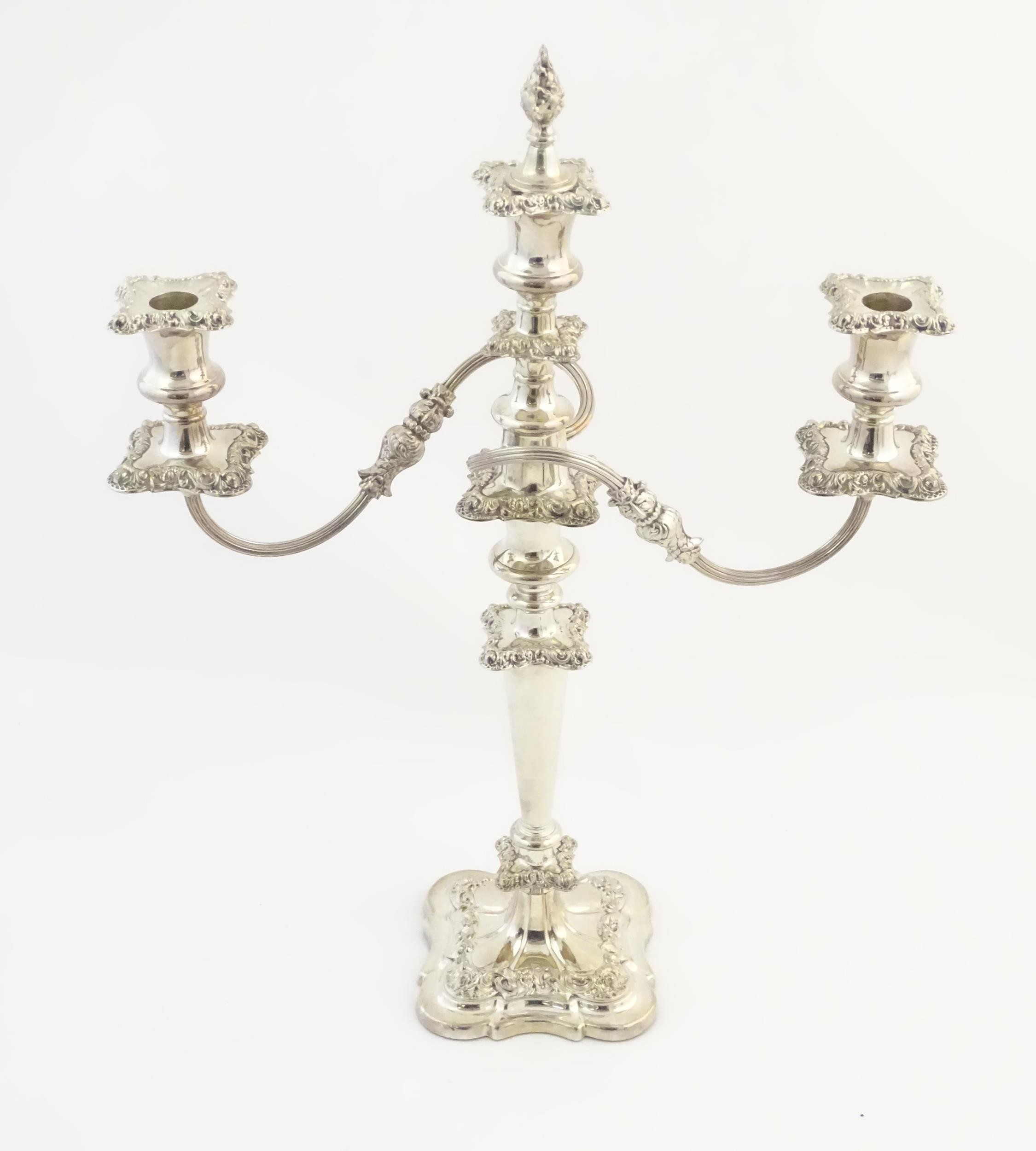 A silver plate table candelabra with two scrolling branches and acanthus scroll detail. Approx 21"