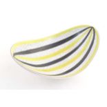 A Swedish mid century studio pottery bowl of shaped form by Stig Lindberg for Gustavsberg. Marked