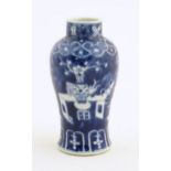 A small Chinese blue and white vase decorated with flowers in a vase and banded borders. Character