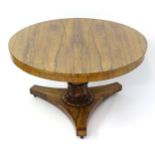 A mid 19thC rosewood centre / breakfast table, having a figured rosewood tilt top above a turned