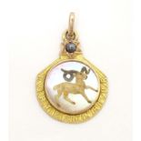 A c.1900 French gold pendant / lucky charm set with Essex crystal style cabochon to centre depicting