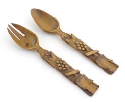 A pair of Continental carved wooden serving spoons / salad servers with stylised fruiting vine