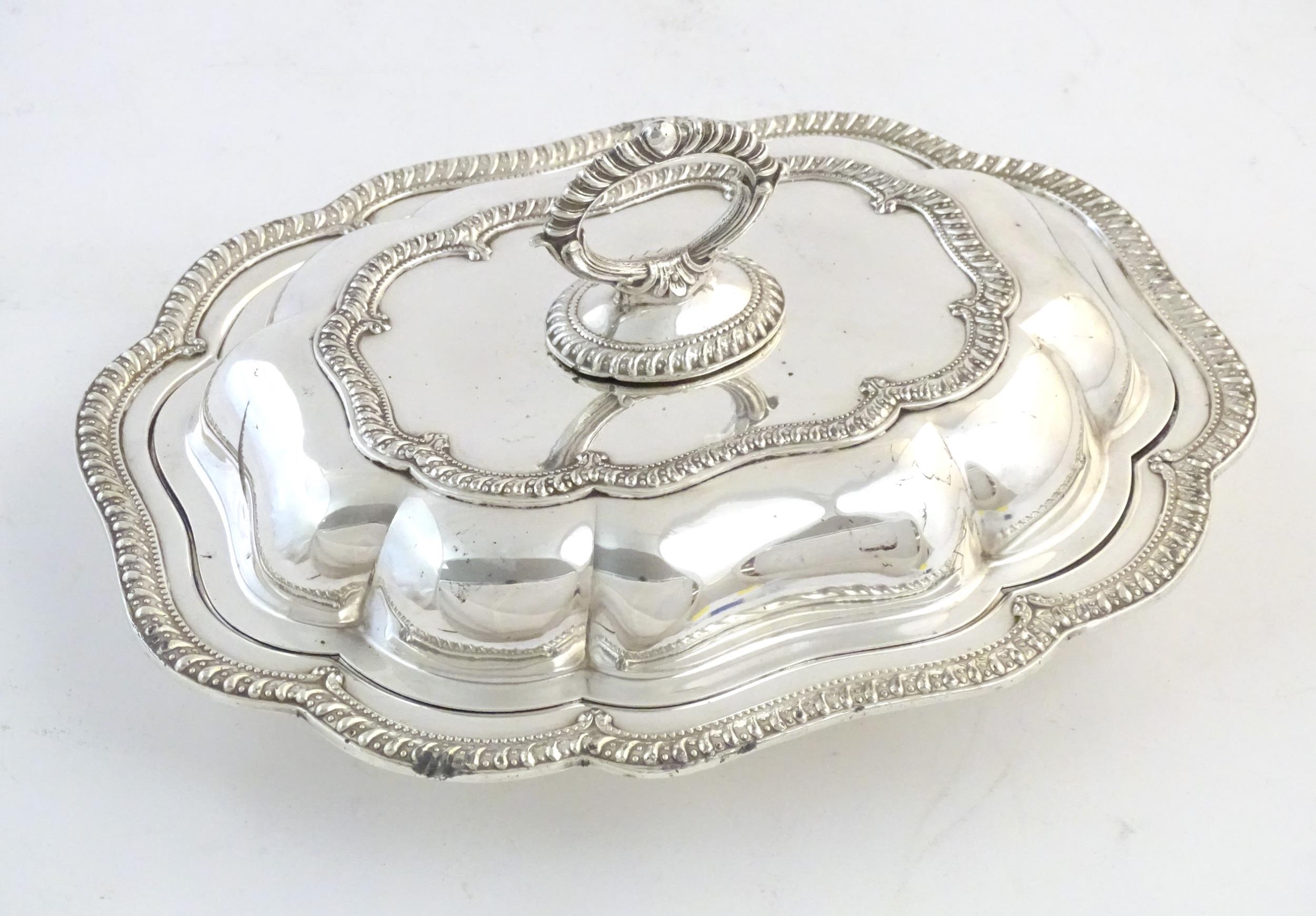 A silver plate serving / entree dish and cover. Approx. 14" wide Please Note - we do not make