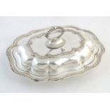 A silver plate serving / entree dish and cover. Approx. 14" wide Please Note - we do not make