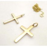 A 9ct gold pendant of cross form with a 9ct gold chain, together with a yellow metal pendant of
