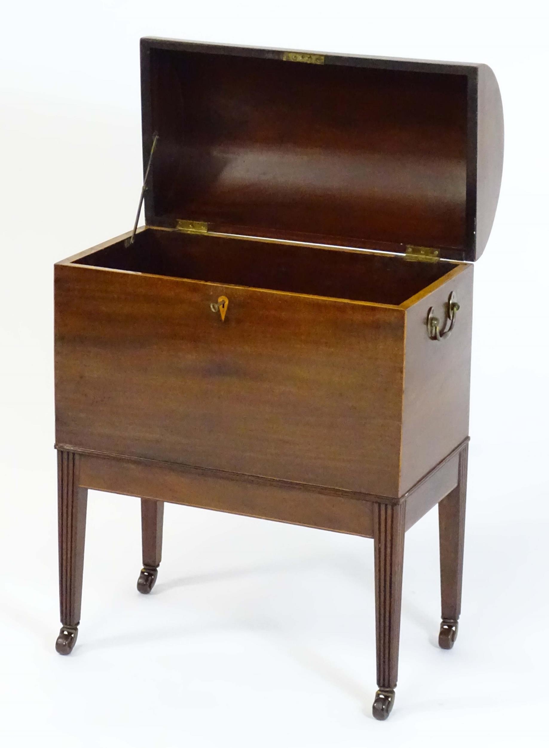 A George III mahogany domed lidded cellarette fitted with dividers for eight bottles, flanked by - Image 4 of 10