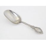 A Victorian silver caddy spoon with oval shield terminal, hallmarked Birmingham 1880, maker George