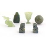 A quantity of Oriental jade coloured hardstone carvings to include two miniature foo dogs, a
