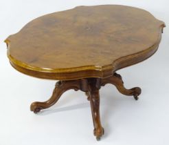 A mid 19thC walnut loo table with a burr walnut veneered top above a turned pedestal base and four