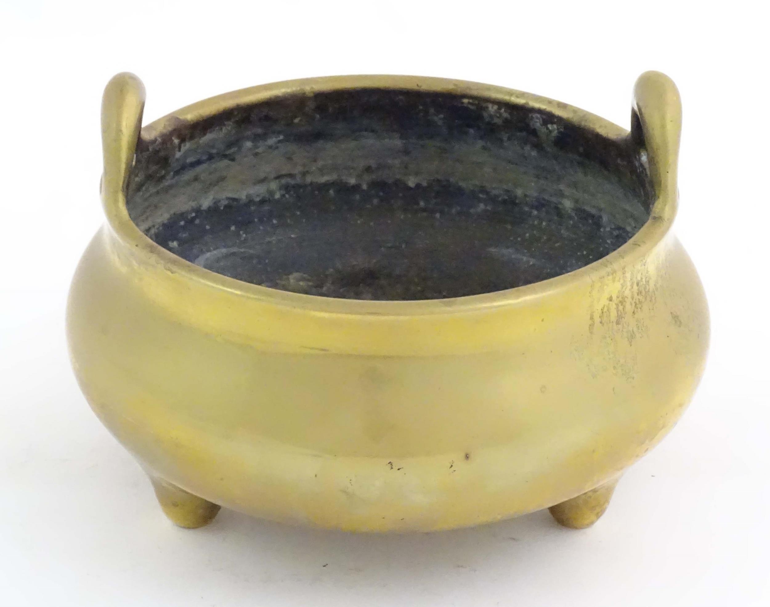 An Oriental three footed censer with twin handles. Character marked under. Approx. 5" high Please - Image 2 of 8