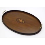 A late 19th / early 20thC mahogany tray of oval form with twin handles and central floral and