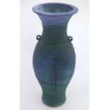 A 20thC studio pottery barium glaze vase by Simon Shaw, with a bulbous body and a flared rim, the