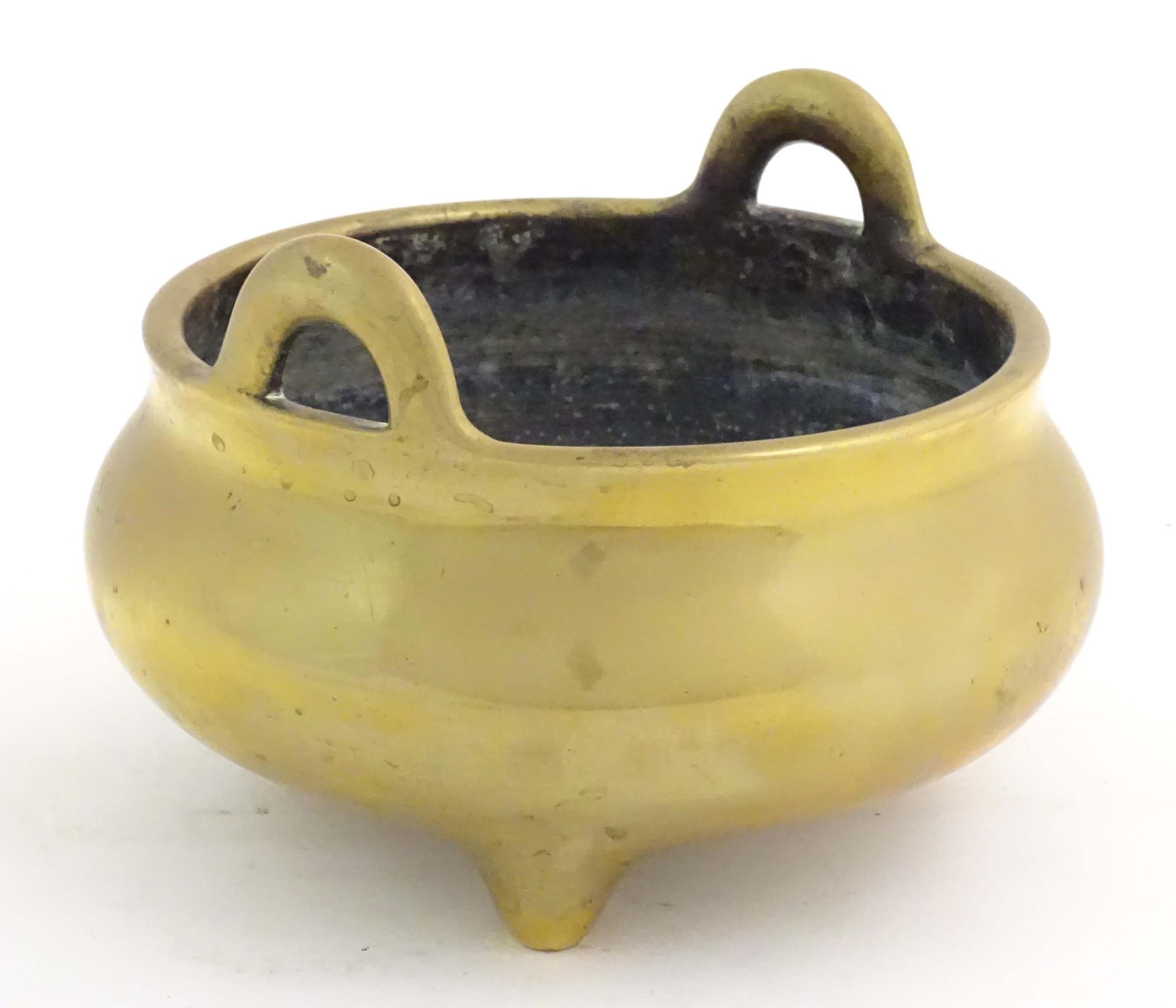 An Oriental three footed censer with twin handles. Character marked under. Approx. 5" high Please - Image 5 of 8