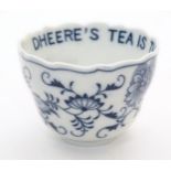 A late 19thC Continental blue and white ceramic tea bowl with floral and foliate decoration. The