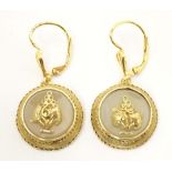 A pair of gold and gilt metal drop earrings set with central chalcedony roundels with applied