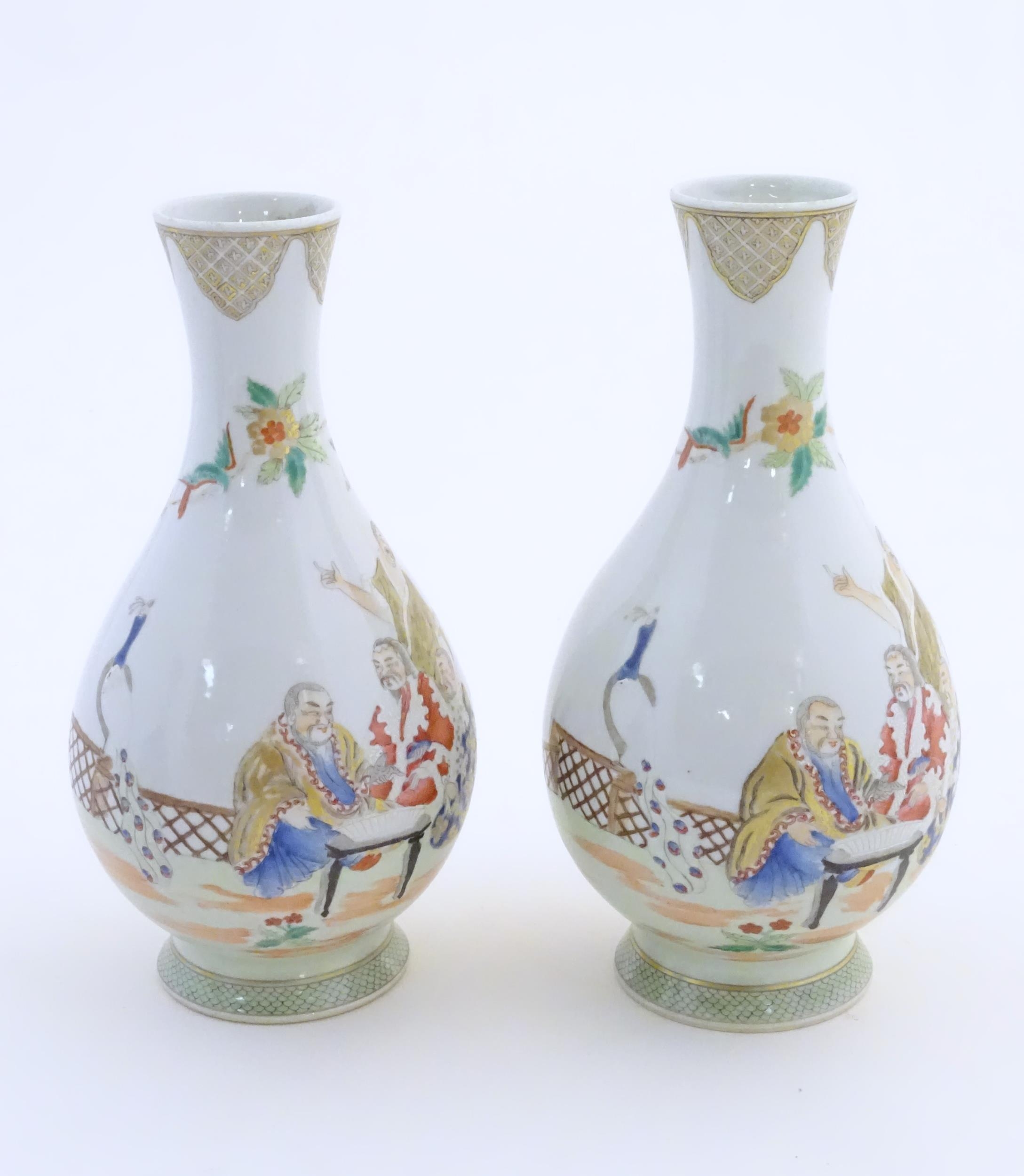 A pair of Chinese famille rose bottle vases decorated with seated figures on a garden terrace, - Image 3 of 6