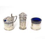 A silver three piece cruet set with blue glass liners comprising salt, mustard and pepperette,