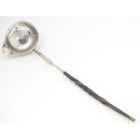 A later 18th / early 19thC white metal toddy / punch ladle with a whale bone handle. Approx. 11 1/2"