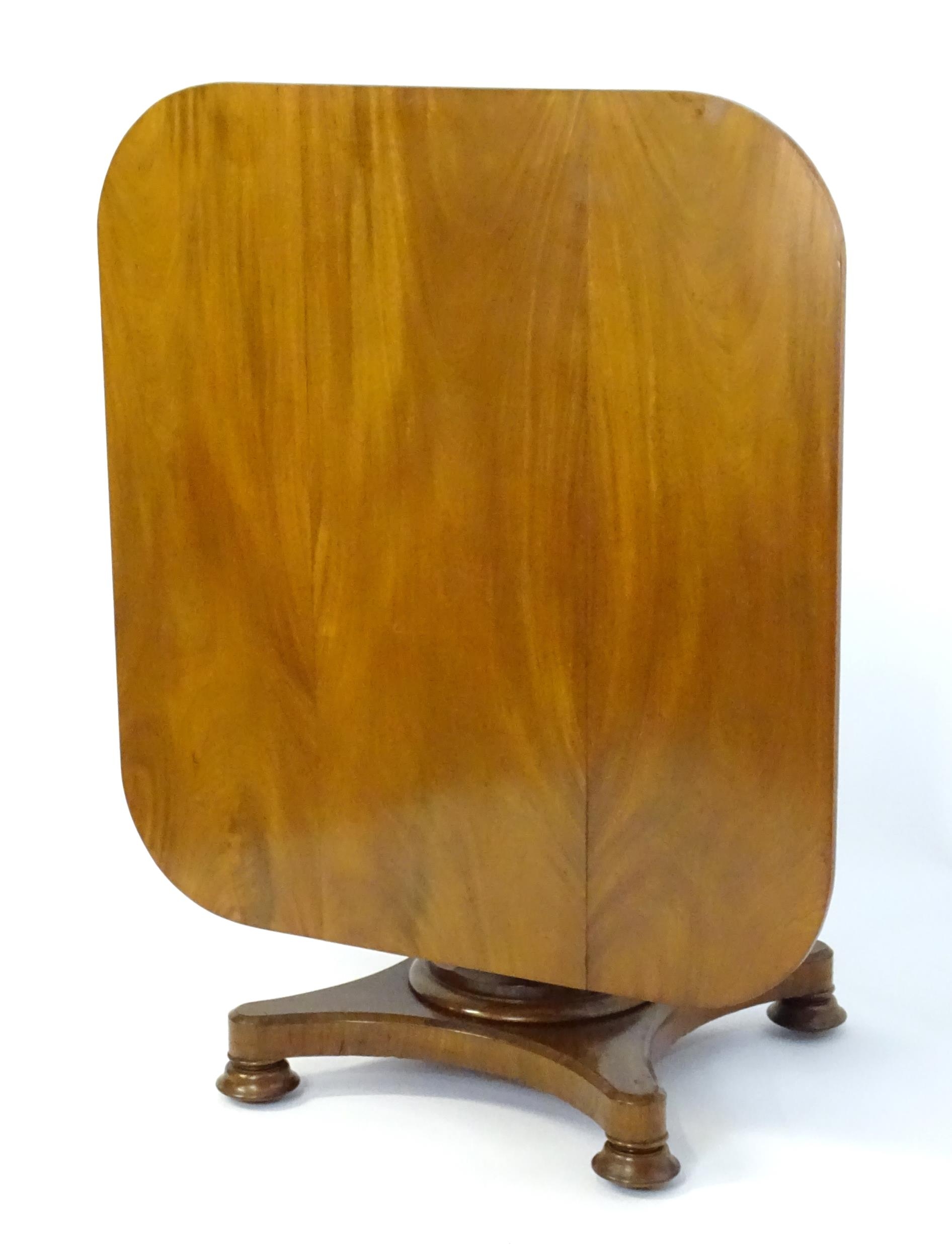 A Victorian mahogany tilt top table with rounded edges and standing on a pedestal base with - Image 5 of 8