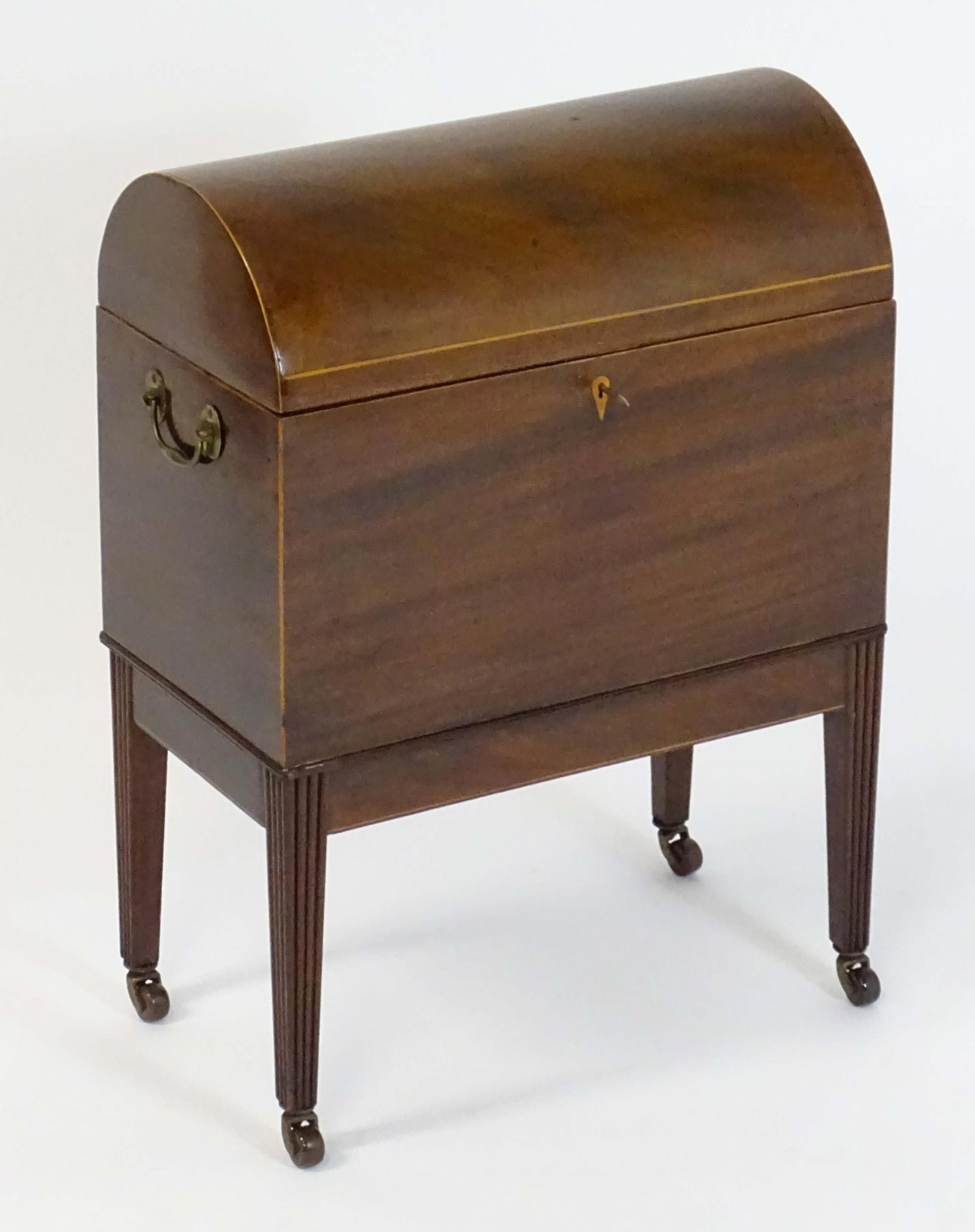 A George III mahogany domed lidded cellarette fitted with dividers for eight bottles, flanked by - Image 7 of 10