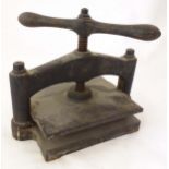 A 19thC cast iron book press, the screw mechanism operating with twin handles compressing two