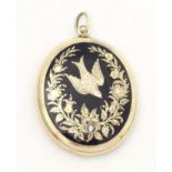 Mourning / memorial jewellery: A Victorian yellow metal pendant locket of oval form with black
