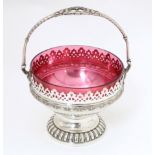 A WMF silver plate sugar bowl with loop handle and cranberry glass liner. Approx. 6 1/2" high