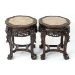 A pair of late 19thC Chinese jardinière stands with shaped floral carved tops surrounding pink