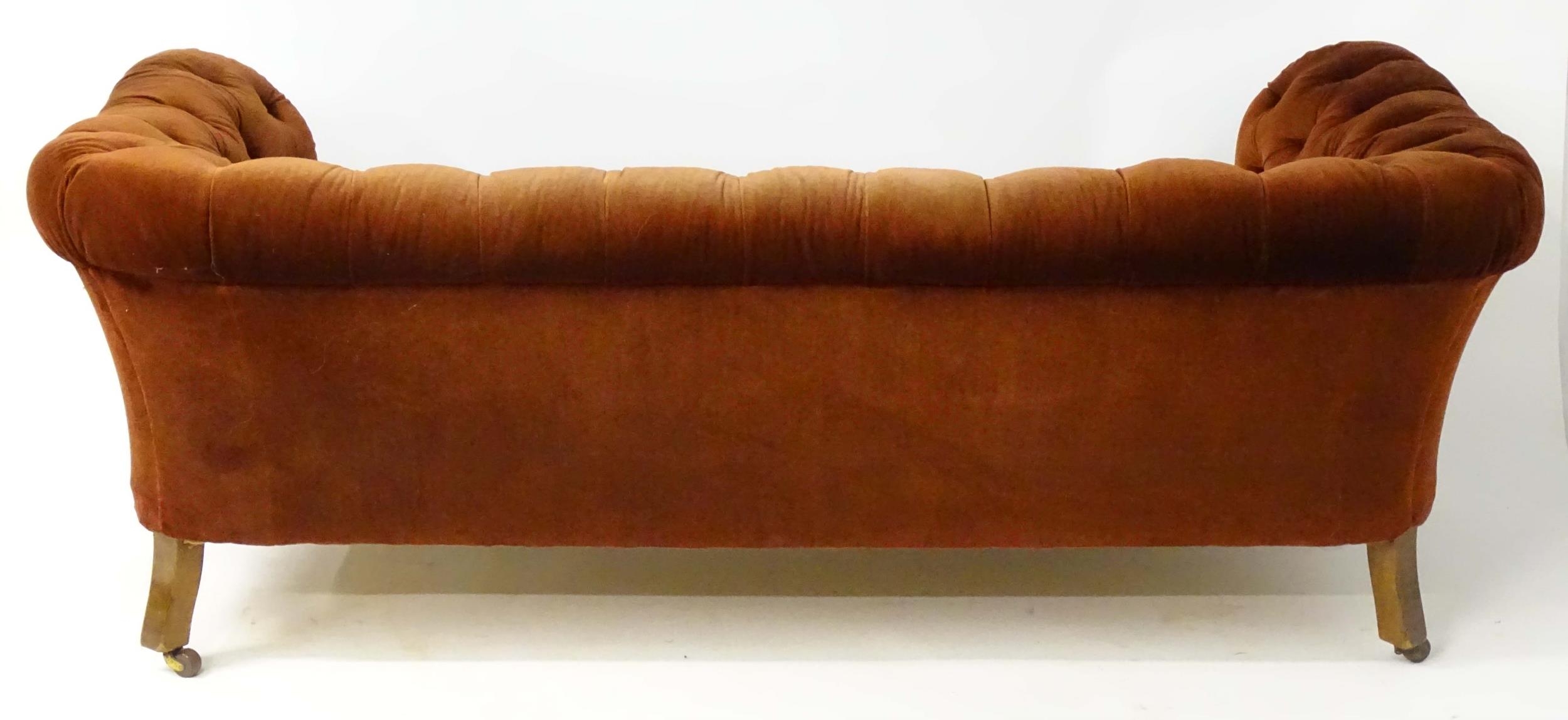 A late 19thC button back chesterfield sofa raised on turned tapering front legs. 81" wide x 37" deep - Image 5 of 5