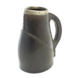 A Victorian Doulton Lambeth pottery jug formed as a leather jack with a silver rim hallmarked London
