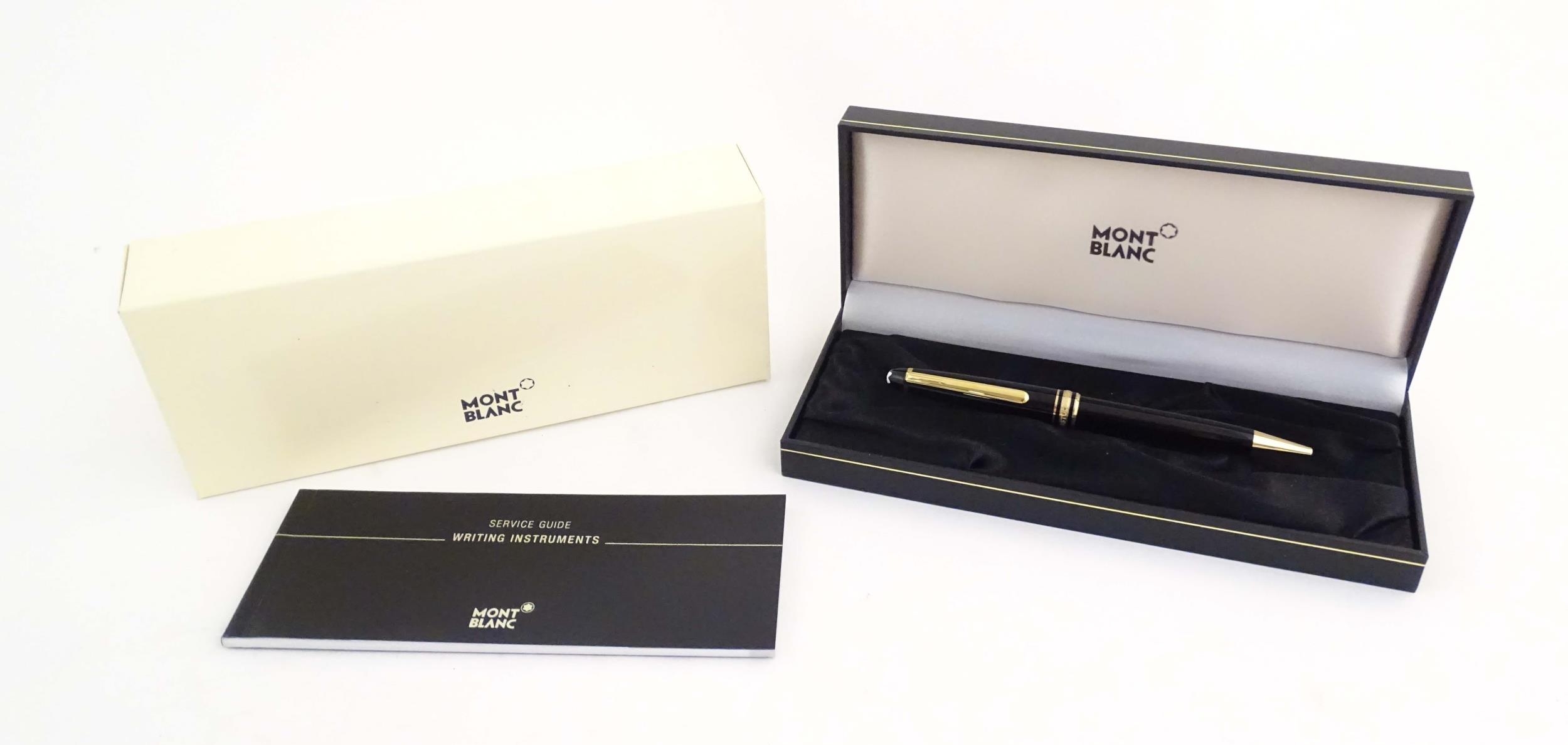 A cased Montblanc 'Meisterstuck' ballpoint pen, in black finish and decorated with gilt banding. - Image 2 of 13