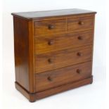 A late 19thC mahogany chest of drawers with a moulded top above two short over three long drawers