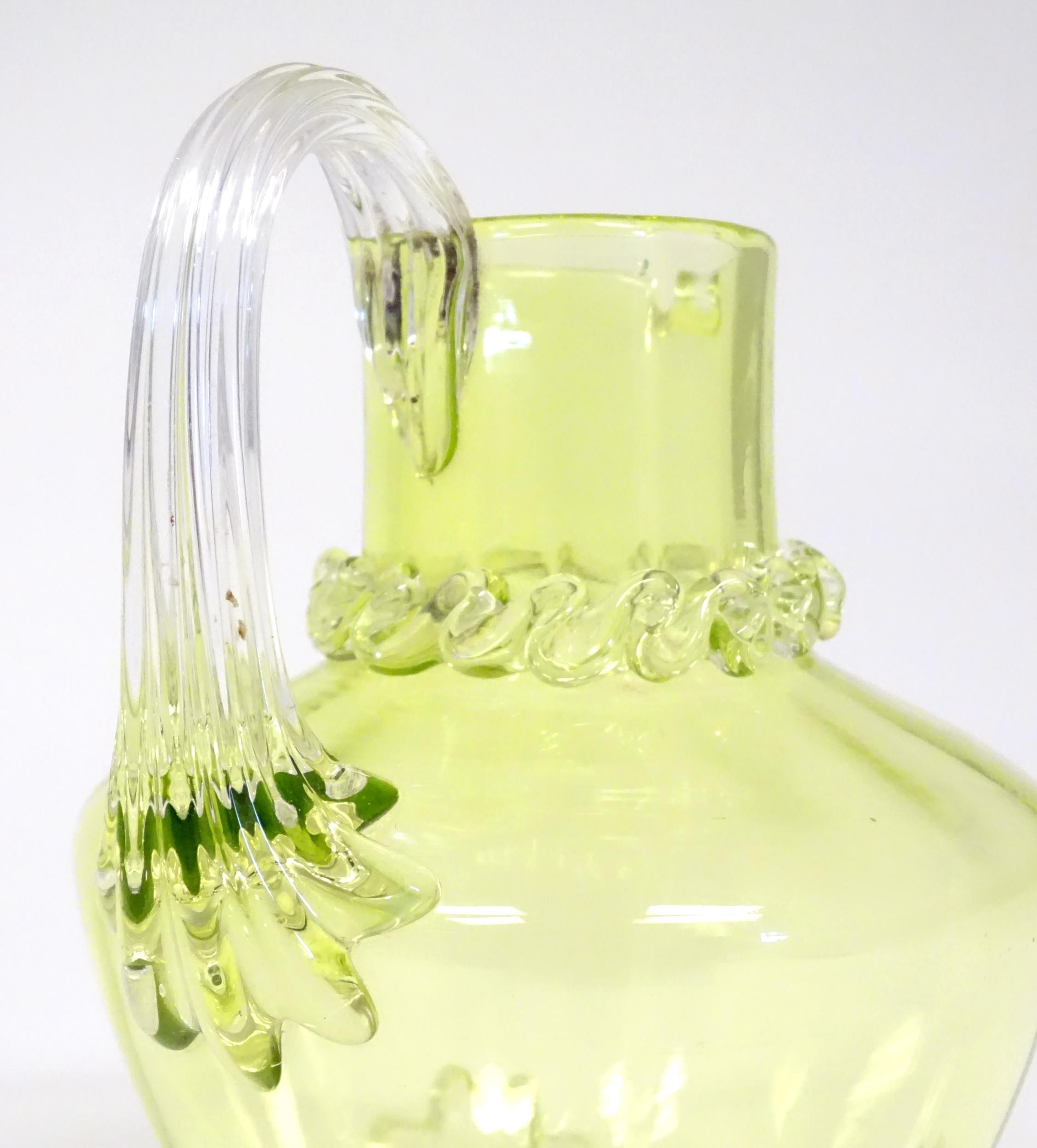 A yellow glass water jug with clear glass handle and feet, together with a matching glass. The jug 6 - Image 5 of 7