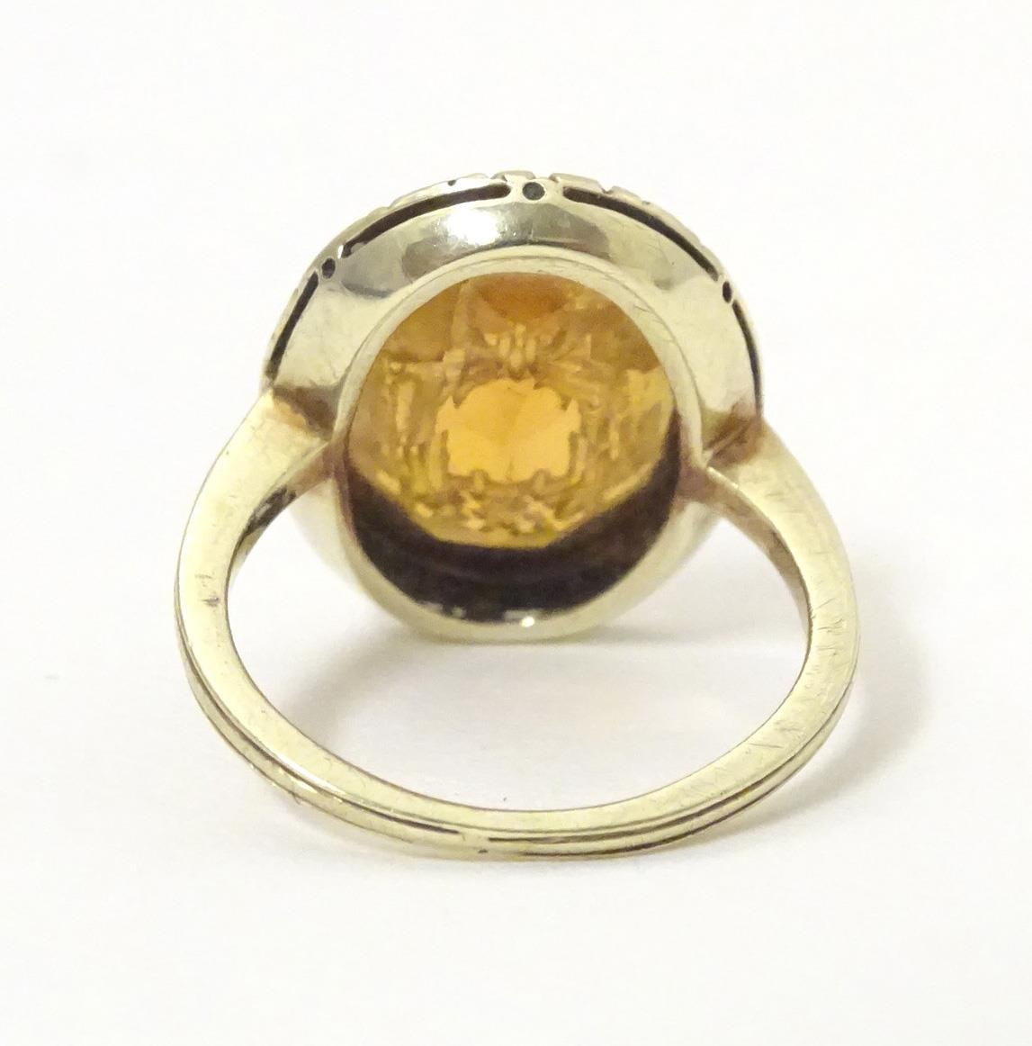 A late 19th / early 20thC yellow metal ring with engraved citrine seal to top depicting monogram. - Image 3 of 6