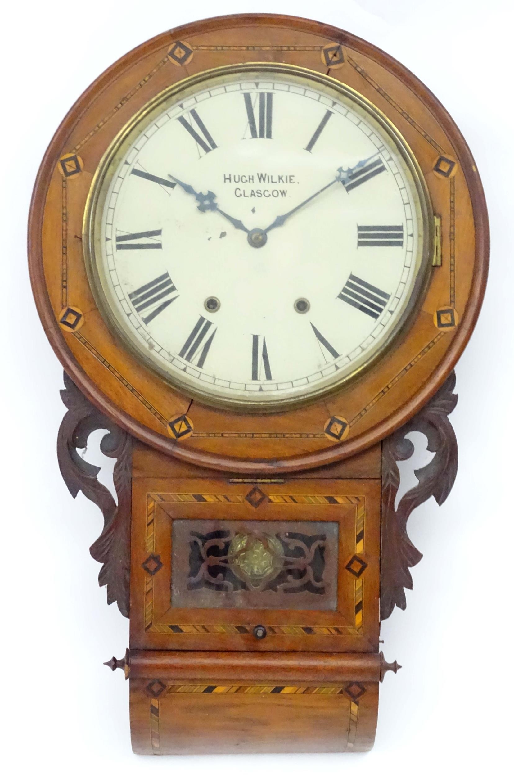 A 19thC drop dial wall clock with inlaid decoration. The 12" dial signed ' Hugh Wilkie Glasgow '.