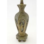 A Chinese carved wooded lamp base of hexagonal form decorated with scenes depicting figures, and