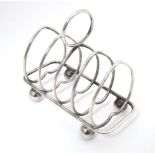 A silver five bar toast rack of heart form, hallmarked Sheffield 1911, maker Walker & Hall.