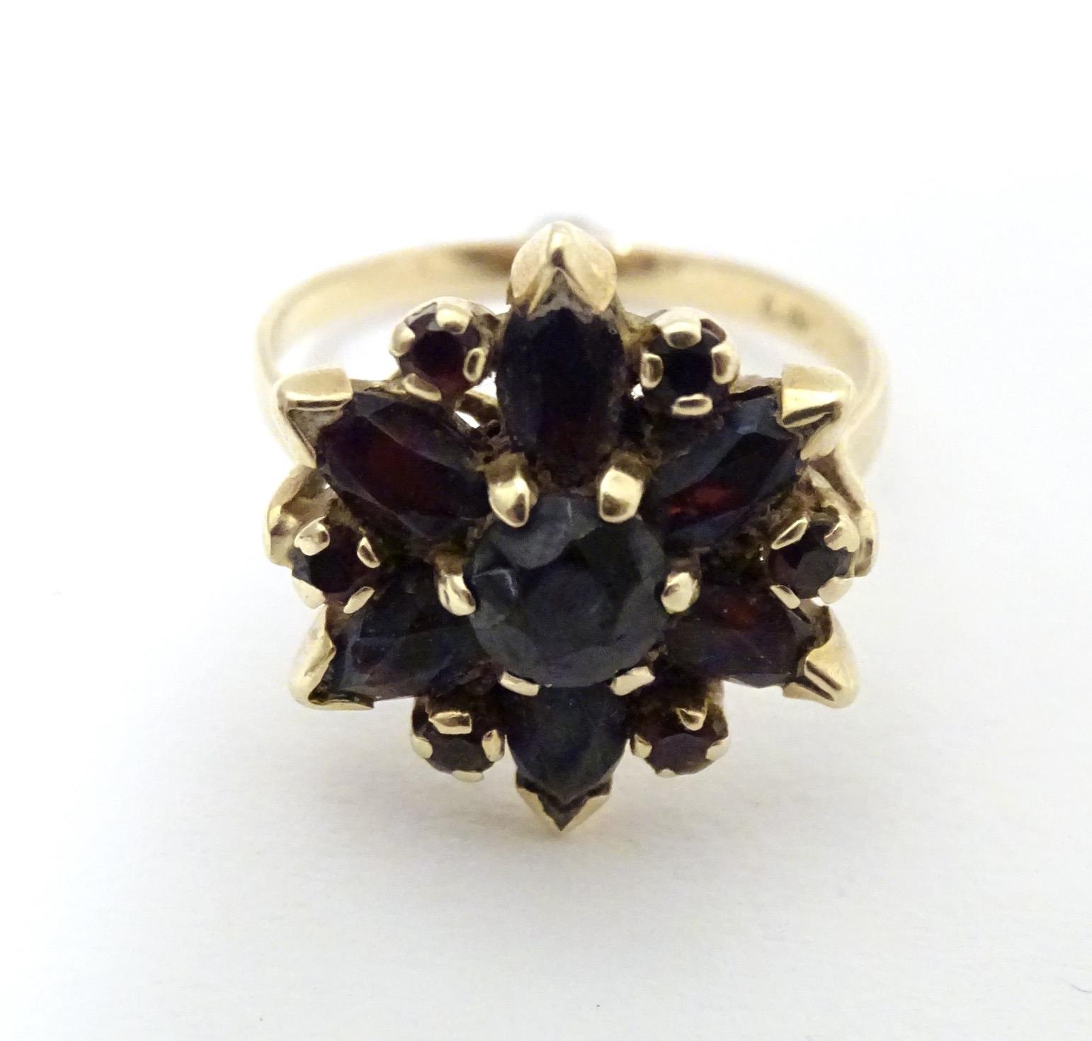 A 9ct gold ring set with garnets. Ring size approx R Please Note - we do not make reference to the - Image 2 of 7