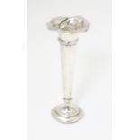 A silver bud vase with flared rim hallmarked Birmingham 1904. Approx. 5 1/2" high Please Note - we