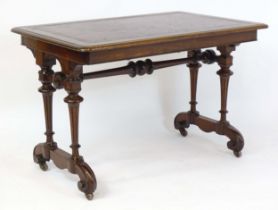 A 19thC mahogany writing table with an inset leather top, raised on four fluted tapering legs with a