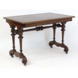 A 19thC mahogany writing table with an inset leather top, raised on four fluted tapering legs with a