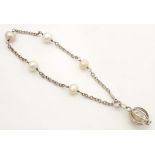 A silver and white metal bracelet set with pearls Please Note - we do not make reference to the