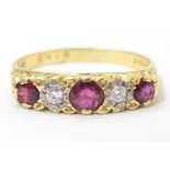 An 18ct gold ring set with diamonds and rubies in a linear setting. Ring size approx. U 1/2 Please
