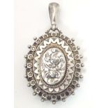 A Victorian silver locket of pendant form with engraved decoration. hallmarked Birmingham 1886.