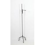 A 19thC wrought iron tallow candle stand, with adjustable branch supporting a single cup, tripod