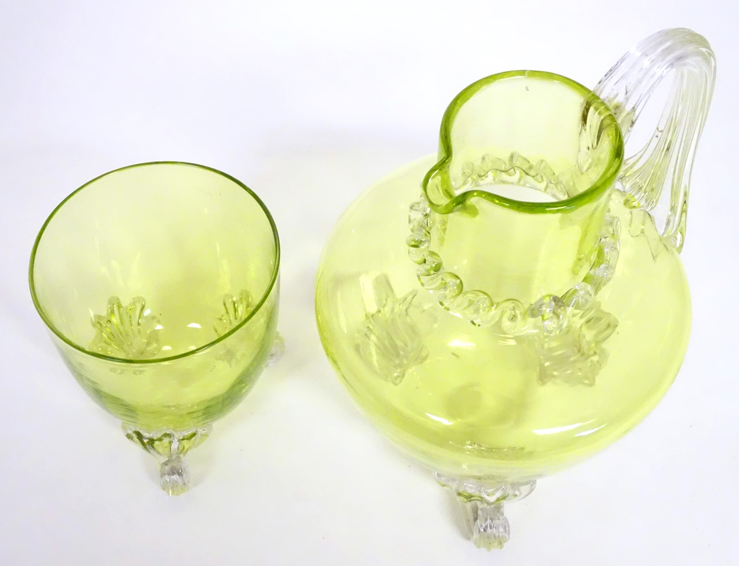 A yellow glass water jug with clear glass handle and feet, together with a matching glass. The jug 6 - Image 4 of 7