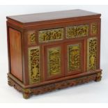 A Chinese red lacquered and gilt chest with a rectangular top above carved gilt drawer and door