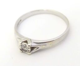 A 9ct white gold ring set with diamond solitaire. the ring approx size L Please Note - we do not