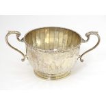 A silver porringer with twin handles, hallmarked Birmingham 1925, maker Walker & Hall. Approx. 6"