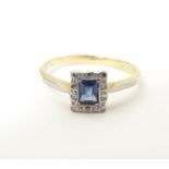 An 18ct gold ring set with central sapphire bordered by diamonds in a platinum setting. Ring size